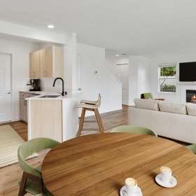 a living room with a table and chairs and a couch