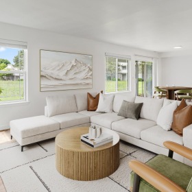 a living room with white furniture