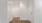 an empty hallway and entrance area with wood floors