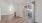 an empty living room with a fireplace and wood floors