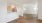 an empty kitchen and dining room area with wood floors
