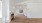 an empty living room with a fireplace and wood floors